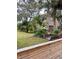 Landscaped yard with wood fence and lush greenery at 5311 Creek Dr, Sarasota, FL 34231