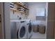 Laundry room with washer, dryer, shelving, and storage at 5311 Creek Dr, Sarasota, FL 34231