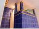Unique shower with blue tile and glass enclosure, offering a modern feel at 5311 Creek Dr, Sarasota, FL 34231