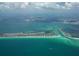 Magnificent aerial view showcasing the beautiful coastline, golf course, and cityscape at 575 Sanctuary Dr # A303, Longboat Key, FL 34228
