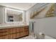 Modern bathroom featuring a double sink vanity, a backlit mirror, and wood cabinetry at 575 Sanctuary Dr # A303, Longboat Key, FL 34228