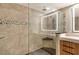 Modern shower with dual shower heads and a corner seat in a renovated bathroom at 575 Sanctuary Dr # A303, Longboat Key, FL 34228