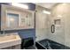 Clean bathroom with marble shower, built-in shelves and a modern vanity at 575 Sanctuary Dr # A303, Longboat Key, FL 34228
