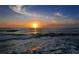 Stunning sunset over the ocean, creating a serene and picturesque beach scene with soft waves at 575 Sanctuary Dr # A303, Longboat Key, FL 34228