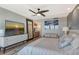 Bright bedroom with large TV, comfortable seating, and beautiful artwork at 575 Sanctuary Dr # A303, Longboat Key, FL 34228