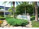 Community entrance sign for The Sanctuary with lush landscaping at 575 Sanctuary Dr # A303, Longboat Key, FL 34228