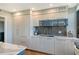 Modern kitchen with white cabinets, quartz countertops, and stainless steel appliances at 575 Sanctuary Dr # A303, Longboat Key, FL 34228