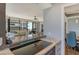 Kitchen features a cooktop, stainless steel appliances, and a view to the living room at 575 Sanctuary Dr # A303, Longboat Key, FL 34228