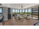 Relaxing living room with large windows and hardwood floors at 575 Sanctuary Dr # A303, Longboat Key, FL 34228