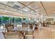 Spacious recreation room with plenty of tables and chairs, perfect for gatherings and socializing at 575 Sanctuary Dr # A303, Longboat Key, FL 34228