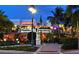 Charming outdoor dining area at a restaurant, beautifully lit and surrounded by lush greenery at 575 Sanctuary Dr # A303, Longboat Key, FL 34228