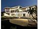 Night view of luxury beachfront home with pool and patio at 639 Cornwell On The Gulf, Venice, FL 34285