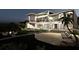 Beachfront home at night with pool and lounge area at 639 Cornwell On The Gulf, Venice, FL 34285
