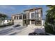 Contemporary home with a two-car garage and palm trees at 639 Cornwell On The Gulf, Venice, FL 34285