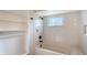 All white bathroom with tiled shower and built-in shelving niche at 640 Venice Ln, Sarasota, FL 34242