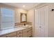 Bathroom features a vanity area, decorative mirror and tile countertop, and adjacent closet at 640 Venice Ln, Sarasota, FL 34242