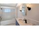 Updated bathroom features a marble vanity top, oil rubbed bronze fixtures, and tiled tub at 640 Venice Ln, Sarasota, FL 34242