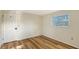 Bright room with a single window, door, and laminate flooring at 640 Venice Ln, Sarasota, FL 34242