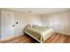 Bedroom with neutral walls, wood-look floors, and closet with white louvered doors at 640 Venice Ln, Sarasota, FL 34242