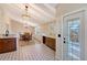 Dining area with hardwood floors, chandelier, and natural light leading into the kitchen at 640 Venice Ln, Sarasota, FL 34242