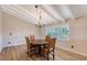 Dining area with hardwood floors, classic chandelier, and a view of the green outdoors at 640 Venice Ln, Sarasota, FL 34242