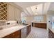 Modern kitchen features designer tile floor, stainless steel dishwasher, and stone backsplash at 640 Venice Ln, Sarasota, FL 34242