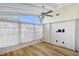 Light-filled sunroom features modern ceiling fan, new flooring, and large windows at 640 Venice Ln, Sarasota, FL 34242