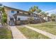 Two-story building with balconies, lush landscaping, and walkways at 6701 Gulf Of Mexico Dr # 311, Longboat Key, FL 34228