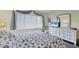 Spacious bedroom with a queen bed and white dresser at 6703 Midnight Pass Rd # 208, Sarasota, FL 34242