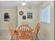 Bright dining area with wood table and four chairs at 6703 Midnight Pass Rd # 208, Sarasota, FL 34242