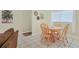 Charming dining area with wood table and four chairs at 6703 Midnight Pass Rd # 208, Sarasota, FL 34242