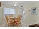 Cozy dining area with wood table and chairs, kitchen view at 6703 Midnight Pass Rd # 208, Sarasota, FL 34242