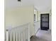 Building hallway with white railing and condo entrance at 6703 Midnight Pass Rd # 208, Sarasota, FL 34242