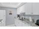 Modern kitchen with white cabinets and granite countertops at 6703 Midnight Pass Rd # 208, Sarasota, FL 34242