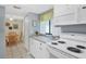 Bright kitchen with granite countertops and white cabinetry at 6703 Midnight Pass Rd # 208, Sarasota, FL 34242