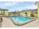 Refreshing community pool with surrounding patio furniture at 6703 Midnight Pass Rd # 208, Sarasota, FL 34242