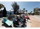 Beachfront street scene with rental scooters, bikes, and cars at 6703 Midnight Pass Rd # 208, Sarasota, FL 34242