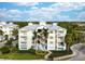 Community of three-story buildings with metal roofs and tropical landscaping at 7610 34Th W Ave # 103, Bradenton, FL 34209