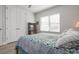 Bedroom with double doors, tiled floor, and a bed with floral bedding at 7610 34Th W Ave # 103, Bradenton, FL 34209