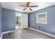 Spacious bedroom with ceiling fan and access to another room at 7720 Judith Cres, Port Richey, FL 34668