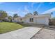 Front view of a single-Gathering home with a driveway and grassy yard at 7720 Judith Cres, Port Richey, FL 34668