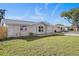 House exterior showcasing a light-colored brick design, a two-car garage, and a neat lawn at 7720 Judith Cres, Port Richey, FL 34668
