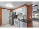 White kitchen cabinets, granite counters and view to backyard at 7720 Judith Cres, Port Richey, FL 34668