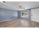 Spacious living area with wood-look floors and a ceiling fan at 7720 Judith Cres, Port Richey, FL 34668