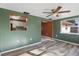 Living area with wood-look floors and kitchen view at 7720 Judith Cres, Port Richey, FL 34668