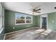Living room with wood-look floors and green walls at 7720 Judith Cres, Port Richey, FL 34668