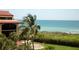 Breathtaking ocean view from this condo with lush tropical landscaping including palm trees and greenery at 8710 Midnight Pass Rd # 205, Sarasota, FL 34242