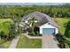 Stunning aerial view of home, showing large lot, brick driveway and landscaping, and tile roof at 931 Mangrove Edge Ct, Bradenton, FL 34208