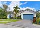 House exterior with a two-car garage, landscaping and brick driveway at 931 Mangrove Edge Ct, Bradenton, FL 34208