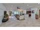 Spacious living room with tile floors, leather sofas, and a view of the pool at 931 Mangrove Edge Ct, Bradenton, FL 34208